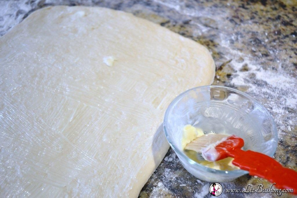 Swedish Tea Ring buttering dough before filling |www.lizbushong.com